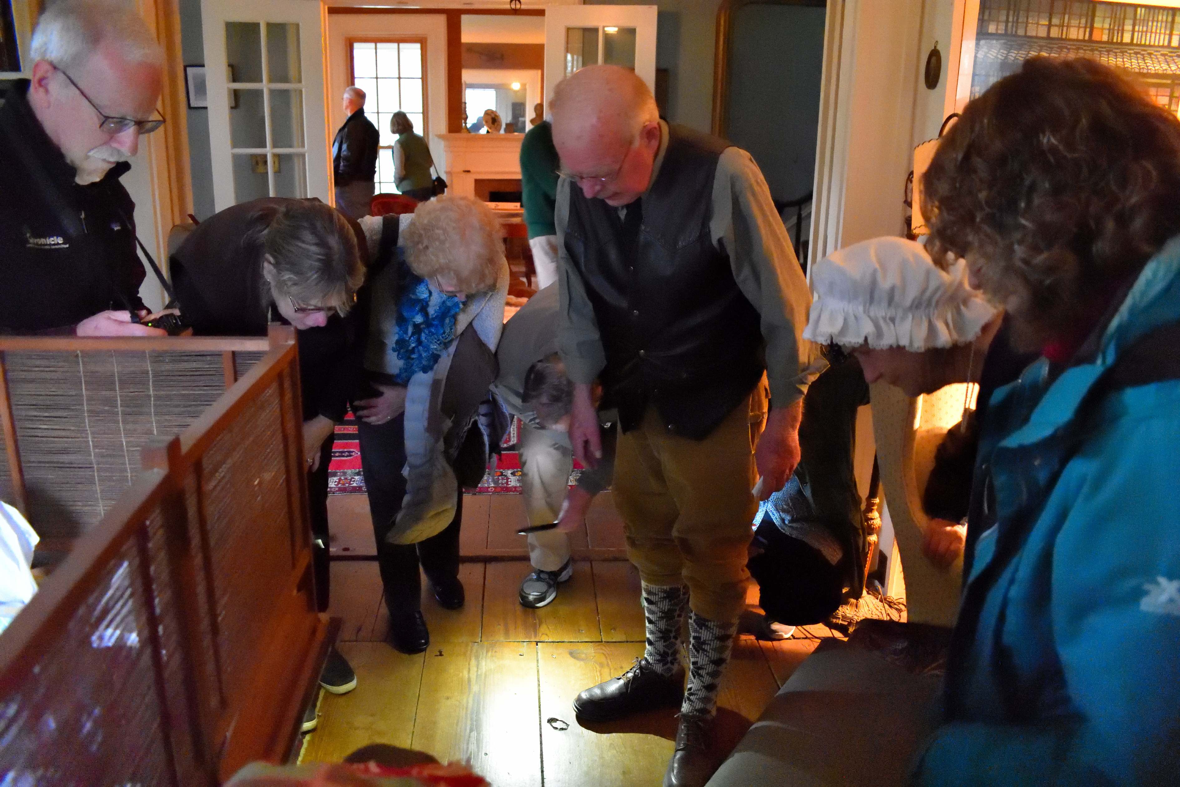 Owner David Bullard showing visitors the blood stains left by wounded soldiers when The Marshall House was used as a hospital during the retreat of the British forces following their defeat at the Battles of Saratoga.
